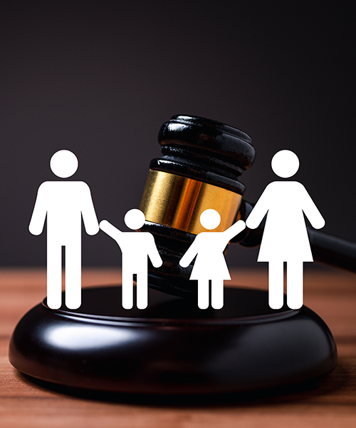 Family of four holding hands next to a judge's gavel, symbolizing justice and family values.