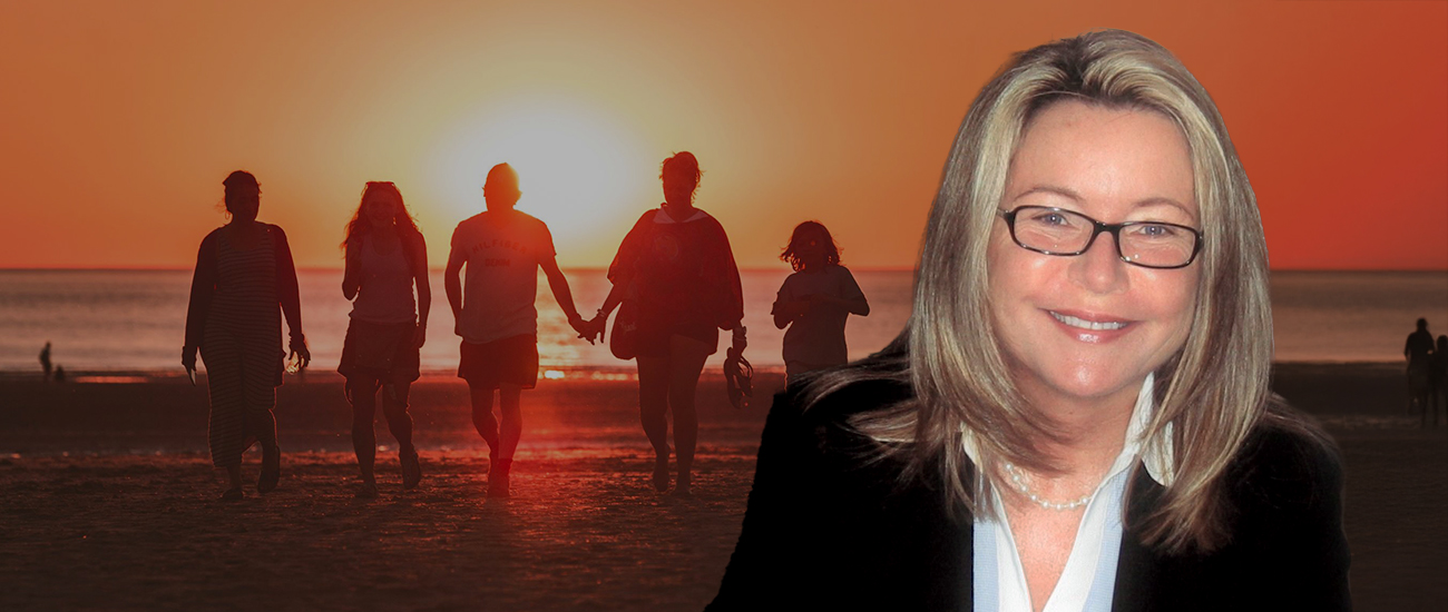 Profile photo of Valerie Hemhauser with a sunset beach background, featuring people walking along the shore.